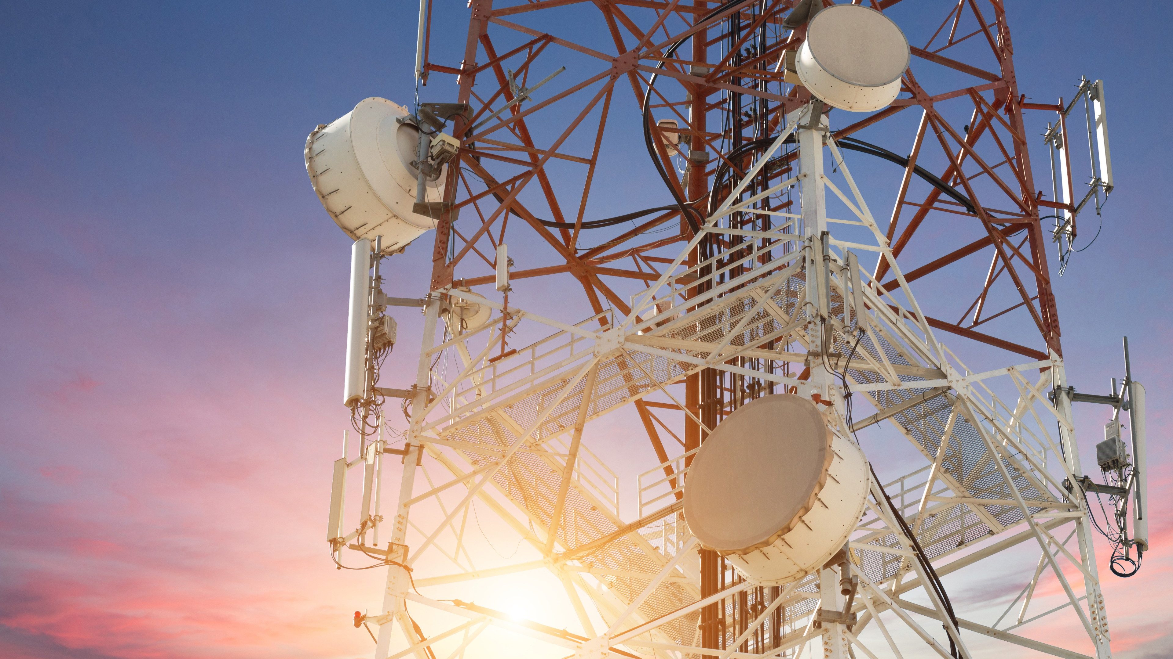 Satellite dish telecom tower at sunset